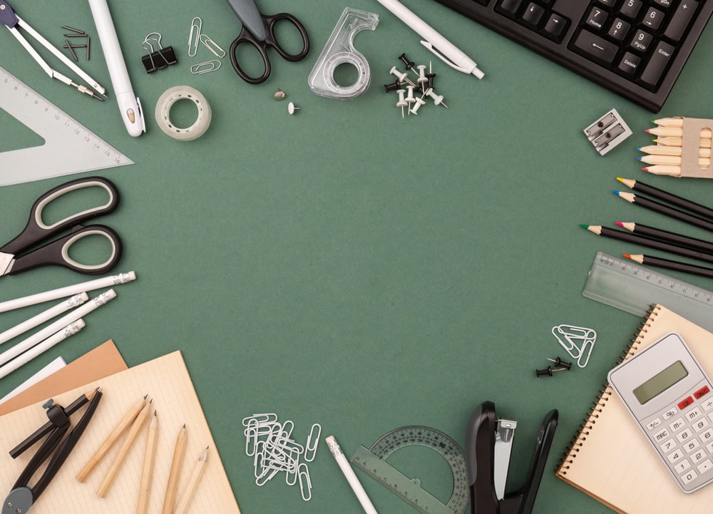Stationery,items,around,of,image,on,green,background.,back,to